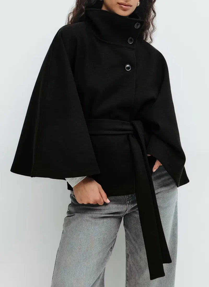 Women’s spring belted high-neck cape coat by Christine Brewer, featuring a funnel neck, short sleeves, and waist belt detail.