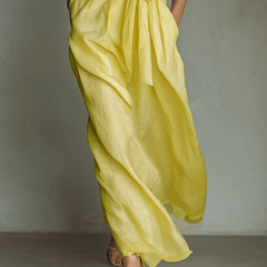 Yellow linen maxi dress for women by Christine Brewer, flowing sleeveless design with a fitted waist and ankle-length hem.