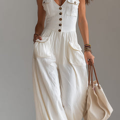 White sleeveless wide-leg jumpsuit with patch pockets, women's pants by Christine Brewer, shown on a model.