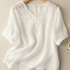 Light beige summer blouse for women by Christine Brewer featuring a V-neck and flowy linen fabric, perfect for casual warm-weather wear.
