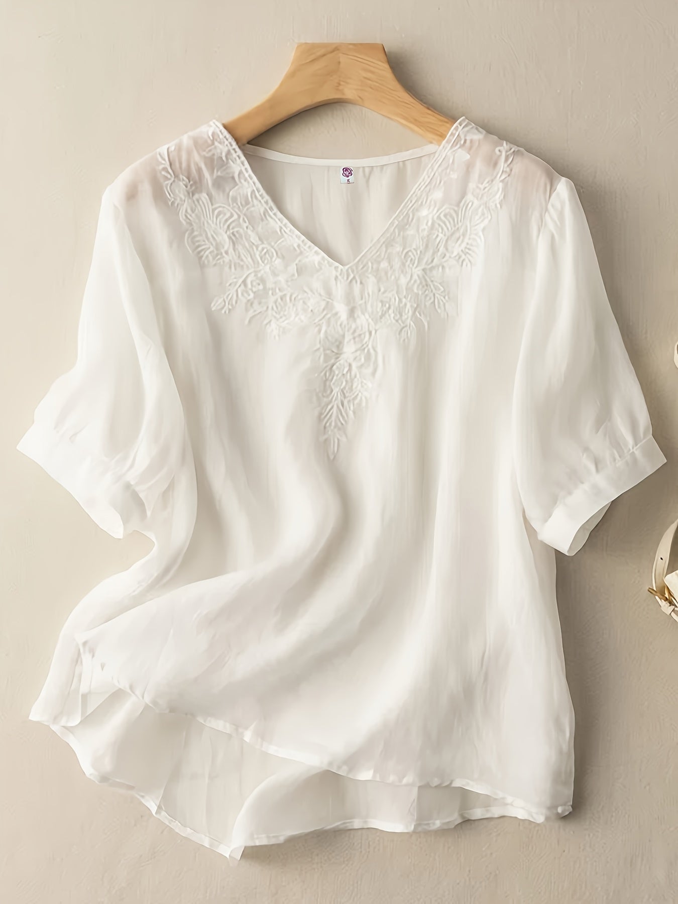 Light beige summer blouse for women by Christine Brewer featuring a V-neck and flowy linen fabric, perfect for casual warm-weather wear.