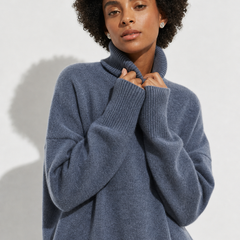Cream-colored Erica oversized turtleneck sweater for women by Christine Brewer, featuring a cozy, relaxed fit and ribbed detailing.