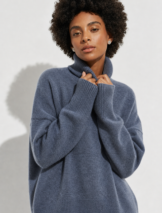 Cream-colored Erica oversized turtleneck sweater for women by Christine Brewer, featuring a cozy, relaxed fit and ribbed detailing.