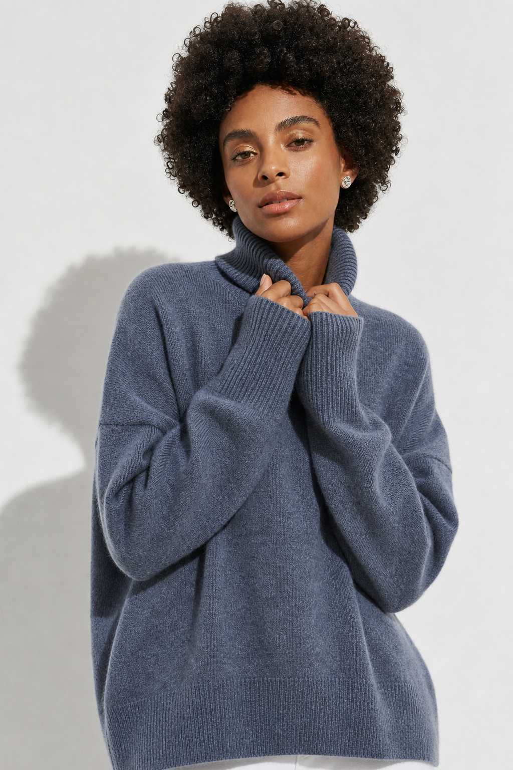 Cream-colored Erica oversized turtleneck sweater for women by Christine Brewer, featuring a cozy, relaxed fit and ribbed detailing.