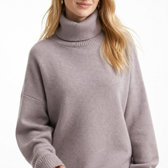 Cream-colored Erica oversized turtleneck sweater for women by Christine Brewer, featuring a cozy, relaxed fit and ribbed details.