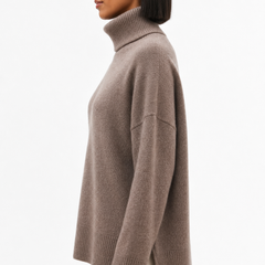 Cream-colored Erica oversized turtleneck sweater for women by Christine Brewer, featuring a cozy, relaxed fit and ribbed details.