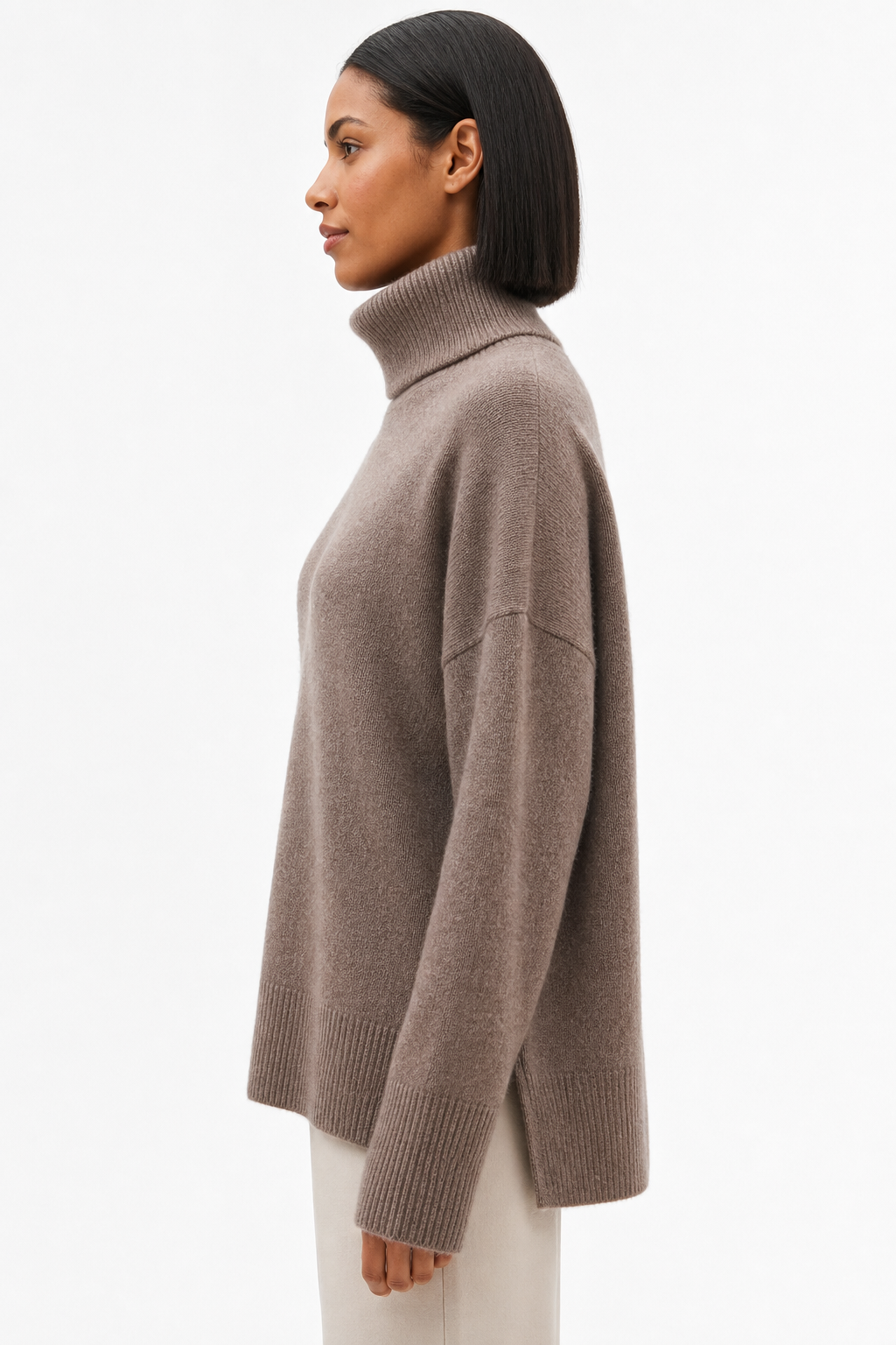 Cream-colored Erica oversized turtleneck sweater for women by Christine Brewer, featuring a cozy, relaxed fit and ribbed details.