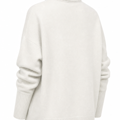 Cream-colored Erica oversized women's turtleneck sweater by Christine Brewer, featuring a cozy, relaxed fit and ribbed knit design.