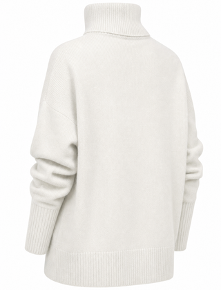 Cream-colored Erica oversized women's turtleneck sweater by Christine Brewer, featuring a cozy, relaxed fit and ribbed knit design.