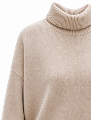 Cream-colored Erica oversized turtleneck sweater for women by Christine Brewer, featuring a cozy fit and knit texture.