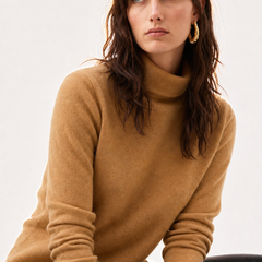 Cream-colored Christine Brewer Gabrielle cashmere turtleneck sweater for women, featuring a cozy fit and classic design.