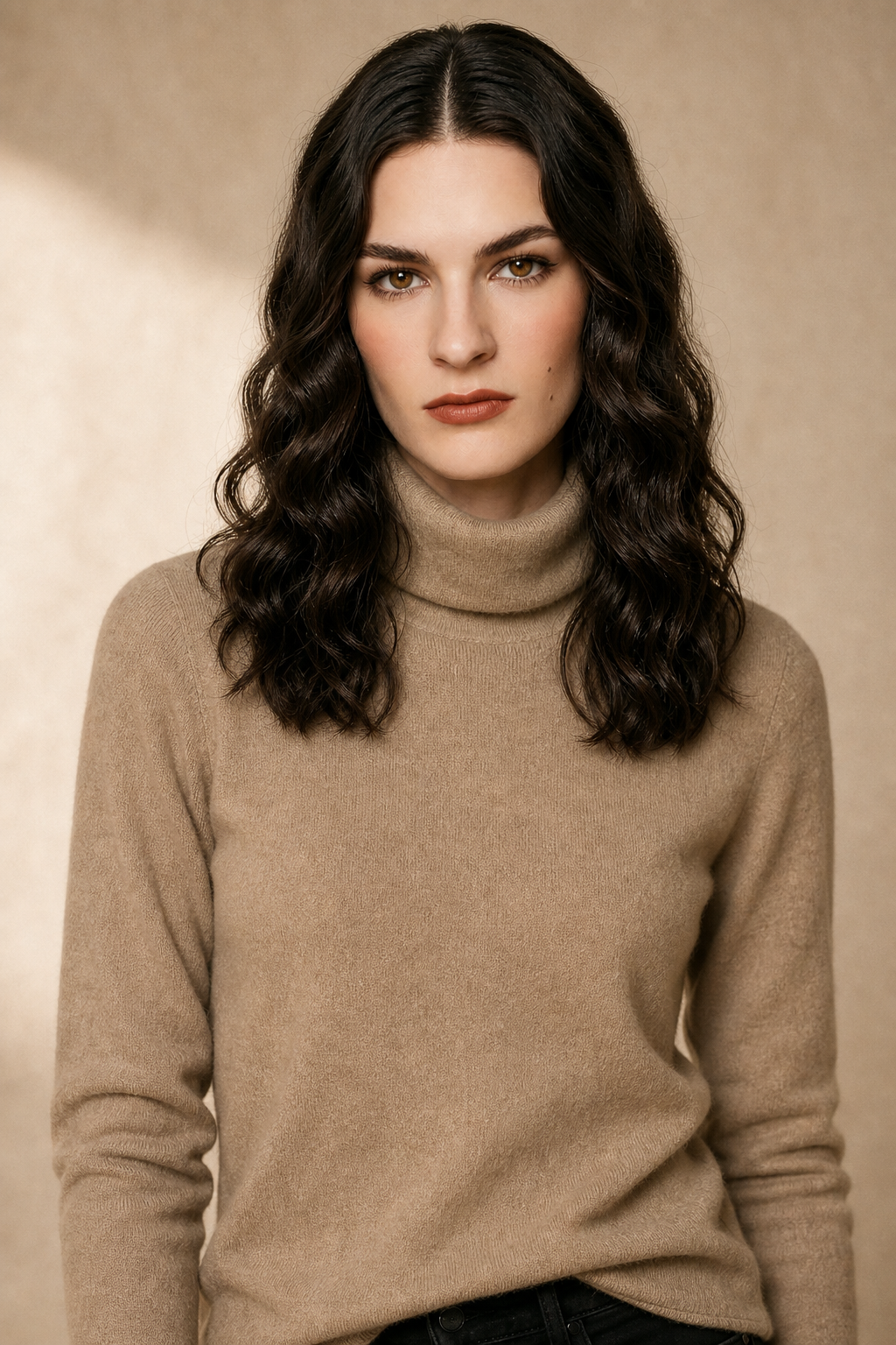 Cream-colored Gabrielle cashmere turtleneck sweater for women, styled with a relaxed fit and ribbed cuffs, by Christine Brewer.