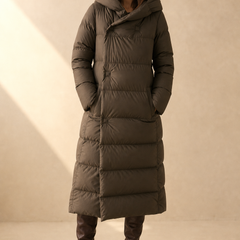 Long hooded women's parka by Christine Brewer featuring a stylish design and a warm, adjustable hood.