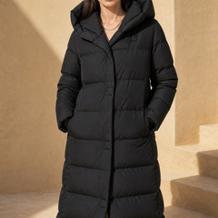 Long hooded parka for women by Christine Brewer, featuring a stylish design with a front zipper and cozy hood.
