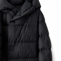 Long hooded women's parka by Christine Brewer with a sleek design, featuring a cozy hood and stylish silhouette.