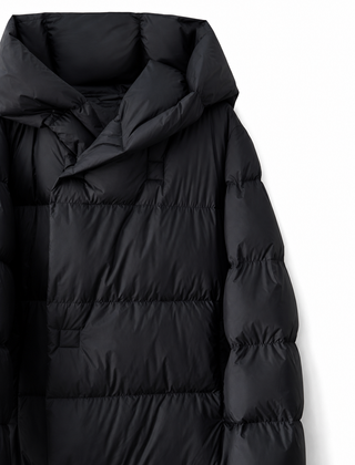 Long hooded women's parka by Christine Brewer with a sleek design, featuring a cozy hood and stylish silhouette.