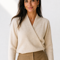 Cream-colored Gwen cashmere V-neck sweater for women by Christine Brewer, shown on a model, highlighting soft knit fabric and stylish fit.