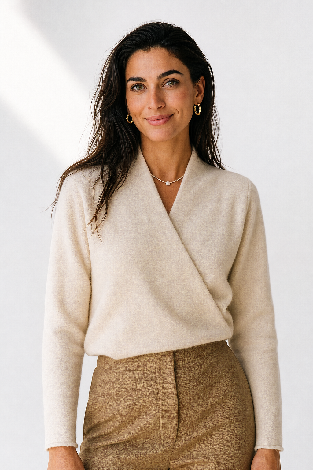 Cream-colored Gwen cashmere V-neck sweater for women by Christine Brewer, shown on a model, highlighting soft knit fabric and stylish fit.