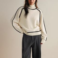 Christine Brewer Eva loose fit roll neck sweater in tailored chic style, soft knit fabric, shown in a relaxed fit and neutral color.