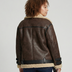 Black faux leather moto jacket for women by Christine Brewer, featuring a classic design with a front zipper and shoulder detailing.