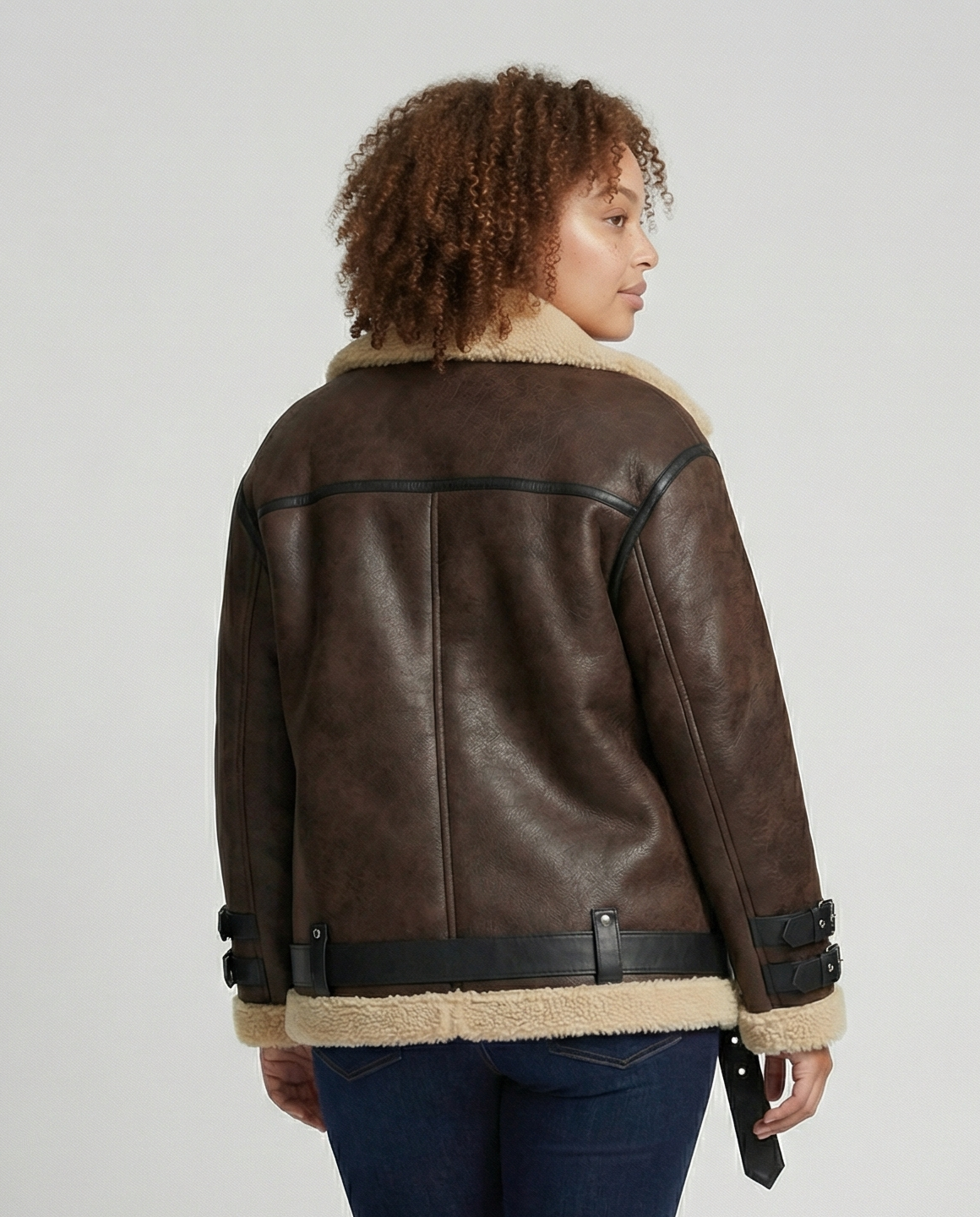 Black faux leather moto jacket for women by Christine Brewer, featuring a classic design with a front zipper and shoulder detailing.