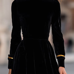 Elegant velvet midi dress with gold trim by Christine Brewer, featuring a fitted bodice and flowing skirt.