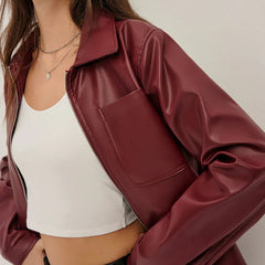 Black zip-up faux leather jacket for women by Christine Brewer, featuring a sleek design and collar detail.