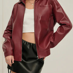 Burgundy zip-up faux leather jacket for women by Christine Brewer, featuring a stylish collar and fitted design.