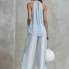 Light blue striped chiffon wide-leg pants for women by Christine Brewer, showing flowy fabric and relaxed fit.