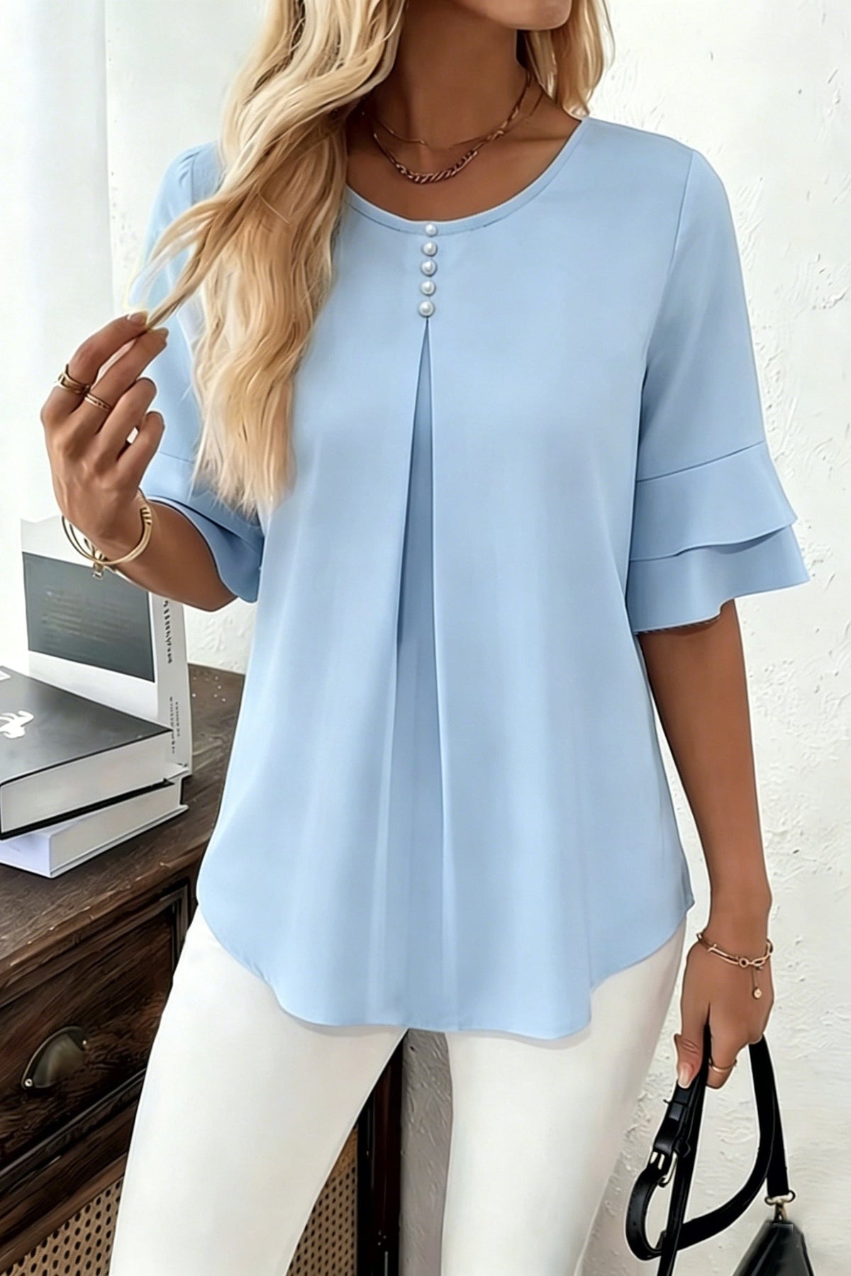 Sophia button-front women's top by Christine Brewer, featuring a stylish design and lightweight fabric, displayed on a hanger.