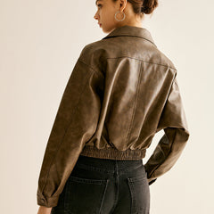 Women’s ruby red faux leather moto jacket by Christine Brewer, featuring classic biker style and silver hardware details.