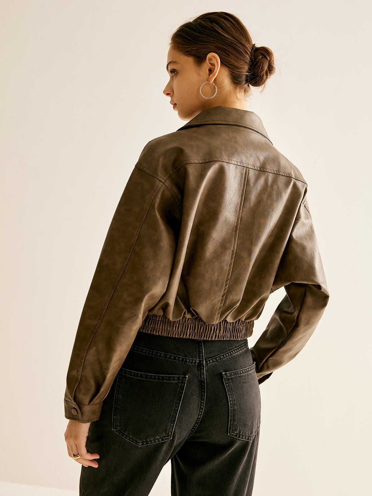 Women’s ruby red faux leather moto jacket by Christine Brewer, featuring classic biker style and silver hardware details.