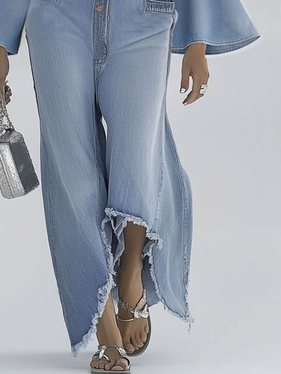 Light blue denim flared long sleeve jumpsuit with wide-leg pants for women by Christine Brewer, shown on a model.