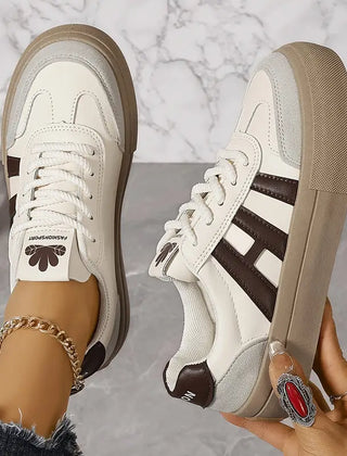 Elegant women's striped flowy sneakers by Christine Brewer featuring a stylish casual design and comfortable fit.