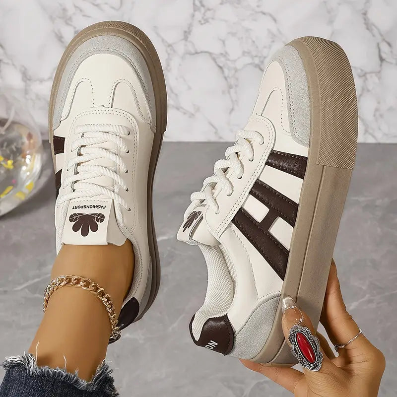 Elegant women's striped flowy sneakers by Christine Brewer featuring a stylish casual design and comfortable fit.