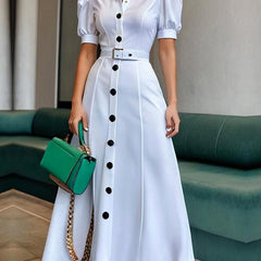 White Christine Brewer maxi dress with puff short sleeves, belted waist, button details, and lapel collar, perfect for elegant summer wear.