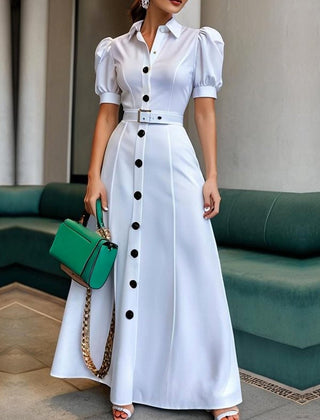 White Christine Brewer maxi dress with puff short sleeves, belted waist, button details, and lapel collar, perfect for elegant summer wear.