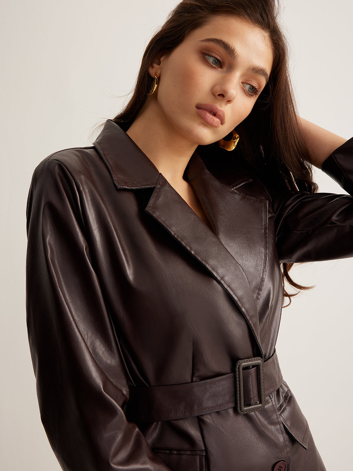 Zoe belted faux leather jacket for women by Christine Brewer, shown in a sleek fit with front belt and classic jacket details.