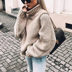 Hazel oversized chunky knit sweater with turtleneck in cozy beige, featuring a relaxed fit and textured knit pattern by Christine Brewer.