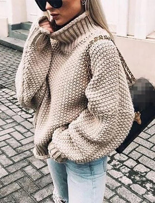 Hazel oversized chunky knit sweater with turtleneck in cozy beige, featuring a relaxed fit and textured knit pattern by Christine Brewer.