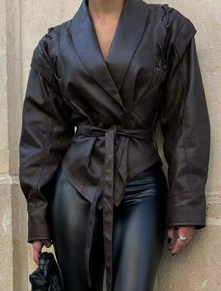 Black faux leather blazer for women by Christine Brewer, tailored jacket with a sleek fit and classic design.