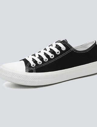 Comfortable women's low top canvas sneakers by Christine Brewer, featuring a casual design and breathable fabric.