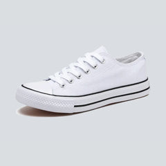 Comfortable women's low-top canvas sneakers by Christine Brewer, featuring a casual design and white laces on a white background.