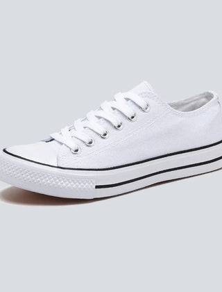 Comfortable women's low-top canvas sneakers by Christine Brewer, featuring a casual design and white laces on a white background.