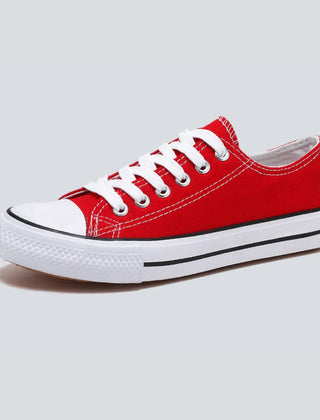 Comfortable women's low-top canvas sneakers by Christine Brewer, featuring a casual design and cushioned soles.