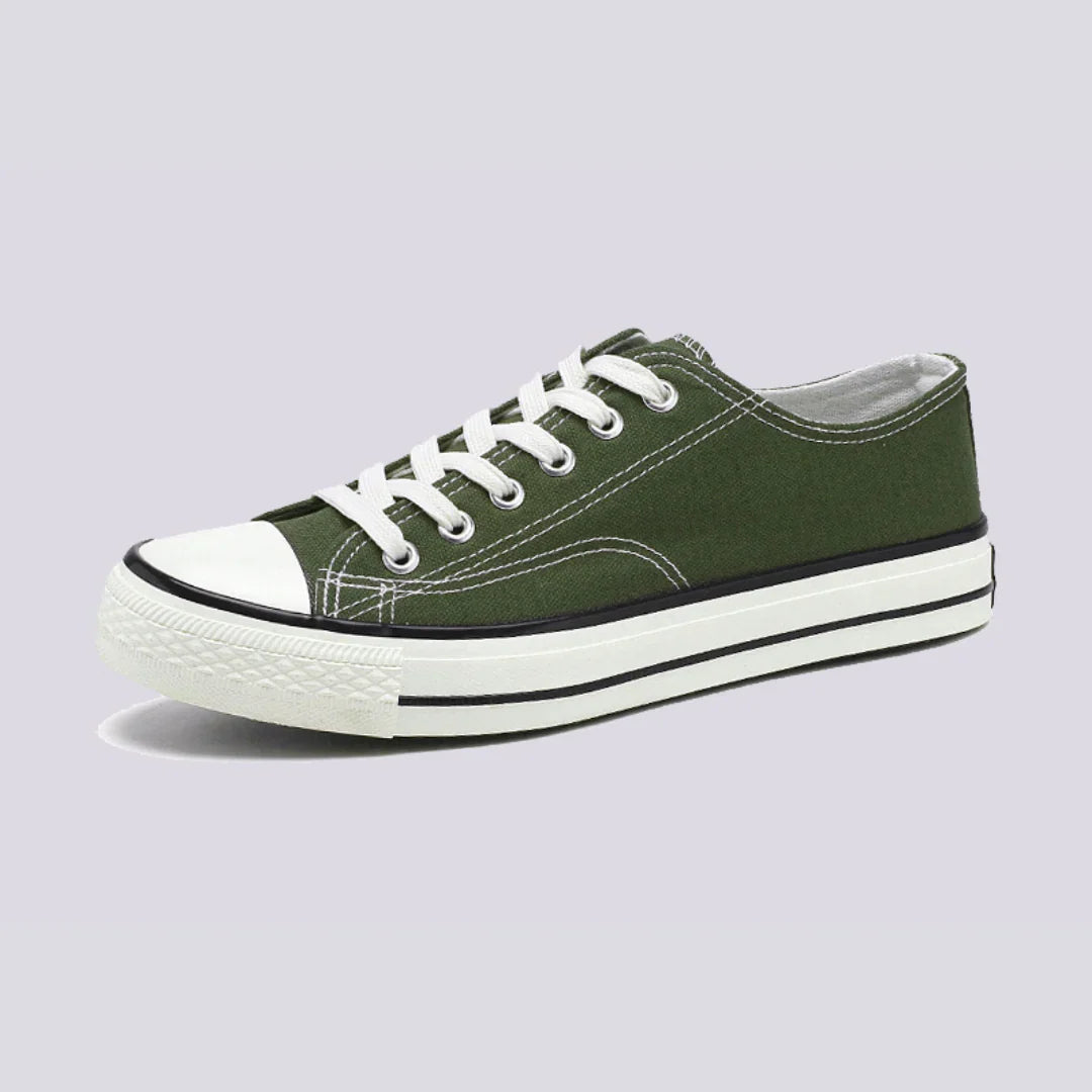 Comfortable women's low-top canvas sneakers by Christine Brewer, featuring a casual design and white laces.