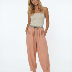 Loose tapered linen trousers for women by Christine Brewer, featuring a relaxed fit and pull-on style in natural linen fabric.