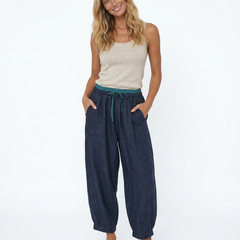 Women’s tapered linen trousers by Christine Brewer, loose pull-on pants with a relaxed fit and natural linen fabric.
