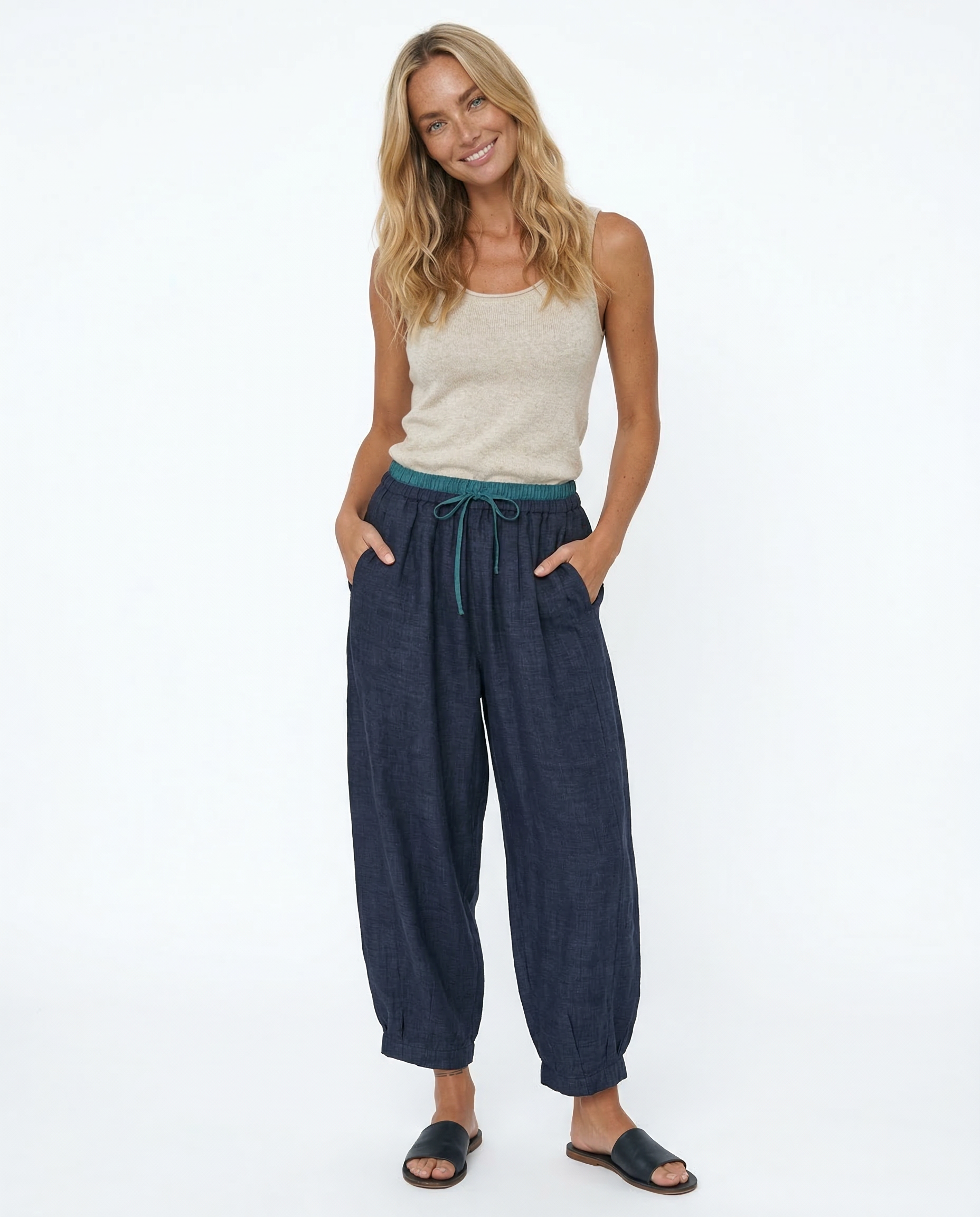 Women’s tapered linen trousers by Christine Brewer, loose pull-on pants with a relaxed fit and natural linen fabric.