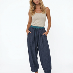 Loose tapered linen trousers for women by Christine Brewer, featuring a relaxed fit and pull-on style in natural linen fabric.